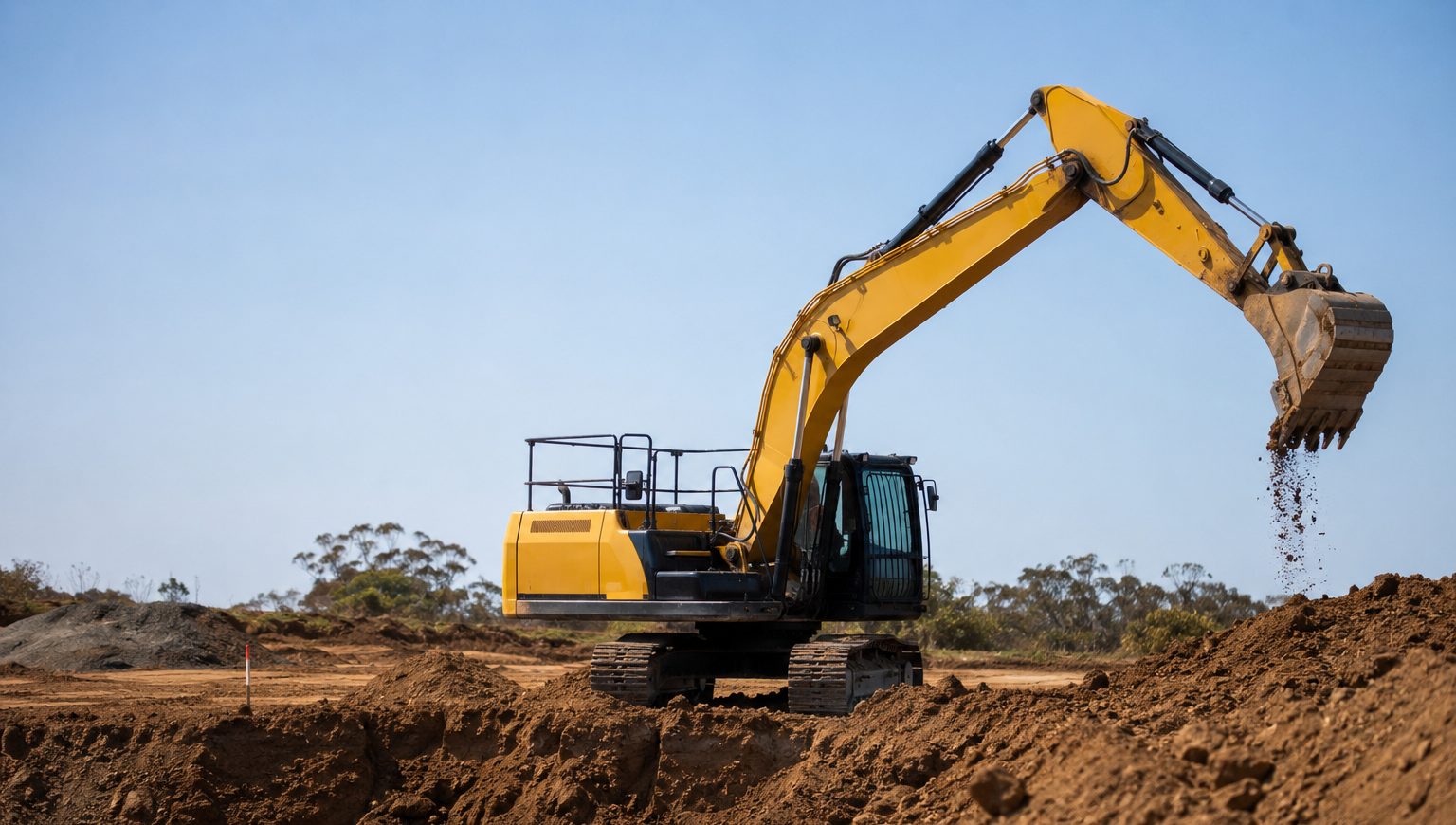 Plant hire yard with skid steers, a roller and a backhoe
